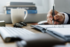 Businessman taking notes on a highly effective feasibility study in Custom Development Solutions office