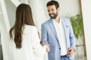 Businessman and woman shaking hands after a feasibility study interview. CDS