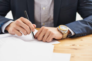 Cropped shot of a businessman making a list about capital campaign planning at Custom Development Solutions