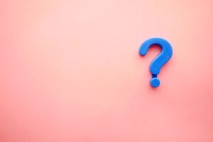 A blue question mark on a pink background. Asking for money is frightening. Custom Development solutions. 