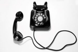 A black dial phone, with the earpiece off the hock. Fundraising Campaign Success depends on phone calls. Custom Development Solutions. 