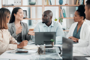 Four people having a campaign meeting at Custom Development Solutions