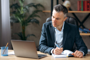 Businessman taking notes on major gift prospects from Custom Development Solutions.