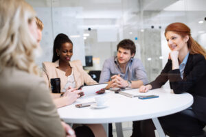 Business people in a modern office having a board meeting including the board chair