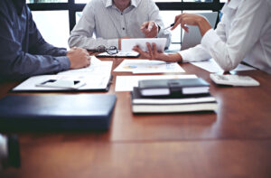 Business people having a Capital Campaign Committee meeting in an office