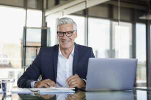 Businessman taking notes on campaigns and annual support for Custom Development Solutions