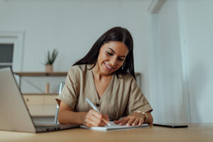 Business woman making a list on growing her pool of major donors using the 12 steps from Custom Development Solutions.