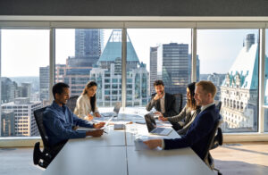 Busy team of office employees in a group meeting discussing a capital campaign plan