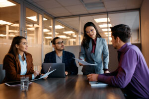 Multiracial group of capital campaign volunteers having a meeting in an office.