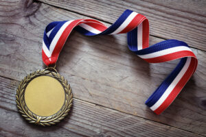 Olympic gold medal on wood background. Go for the gold in your fundraising efforts!