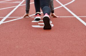 A person ready at a racetrack starting line. Let CDS teach you how to keep your momentum going and transition into a capital campaign.