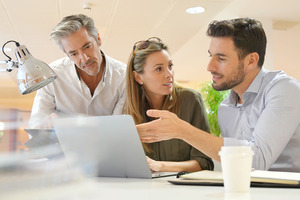 A group of employees works on a nonprofit digital advertising campaign